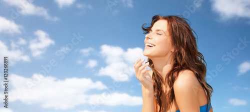 happy beautiful woman over blue sky and clouds