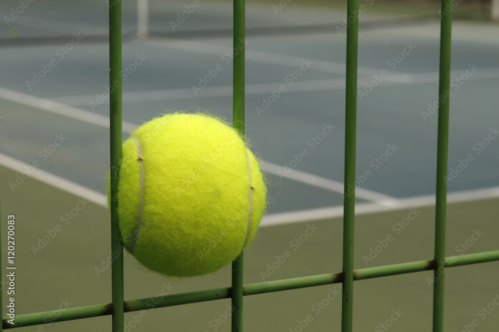 tennis ball and Steel fence in hard court