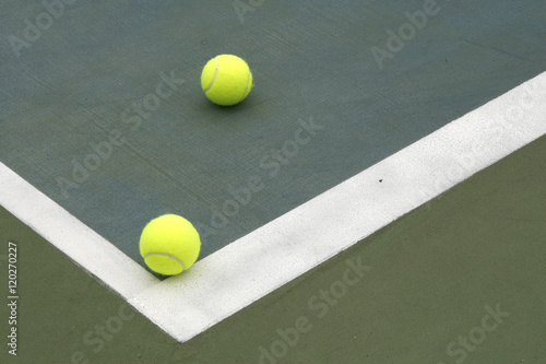tennis balls on hard court