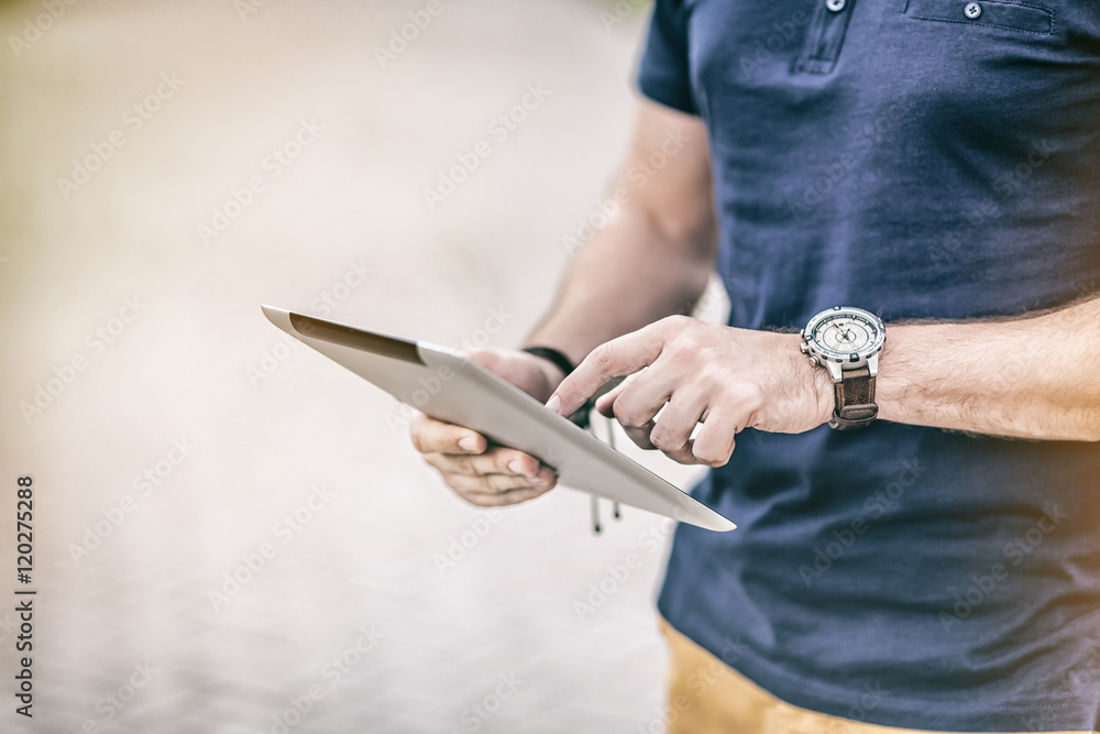 Man with cool watch holding digital Tablet, finger touching screen
