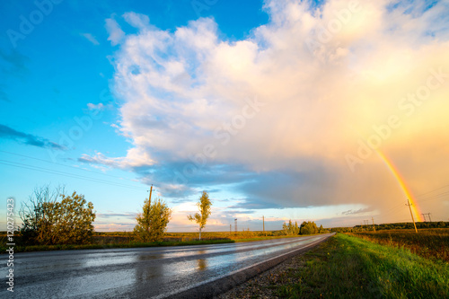 Tableau sur toile Landscape with country road and rainbow