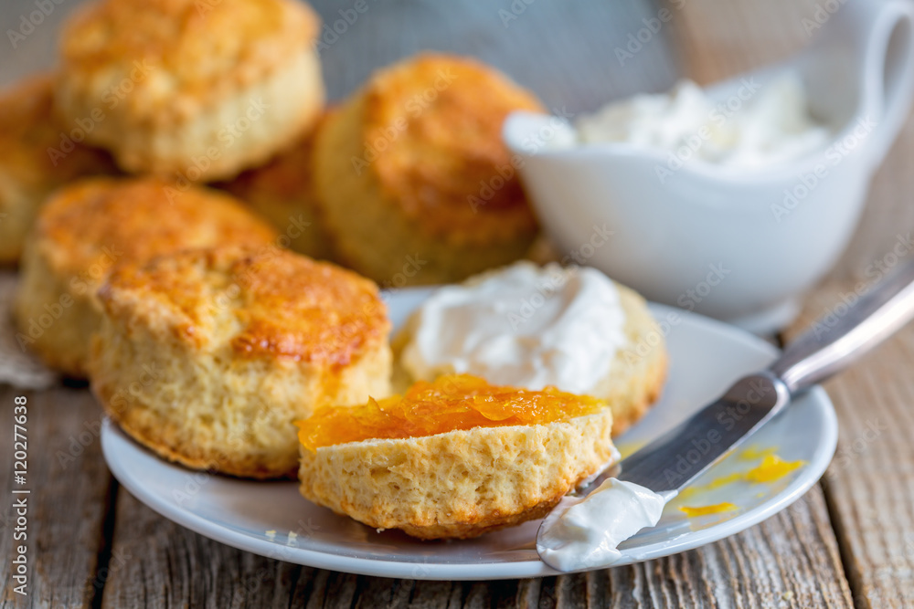 Scones with orange jam and whipped cream. Scones with orange jam and whipped cream.