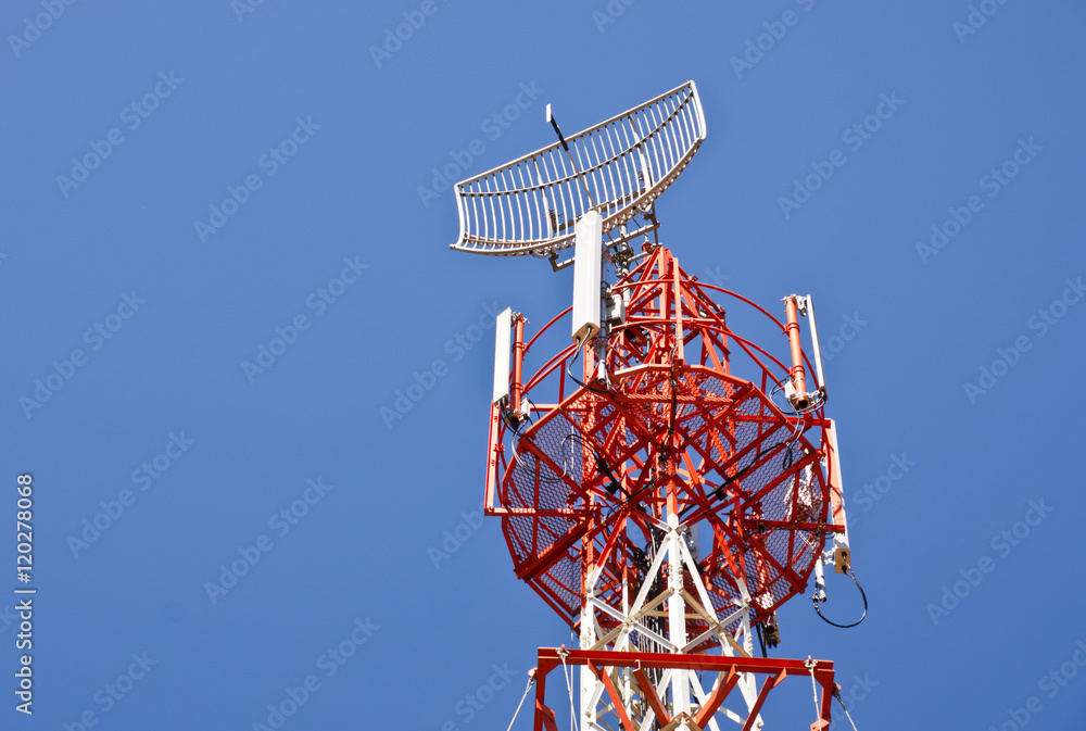 communication tower with different antennas against blue sky