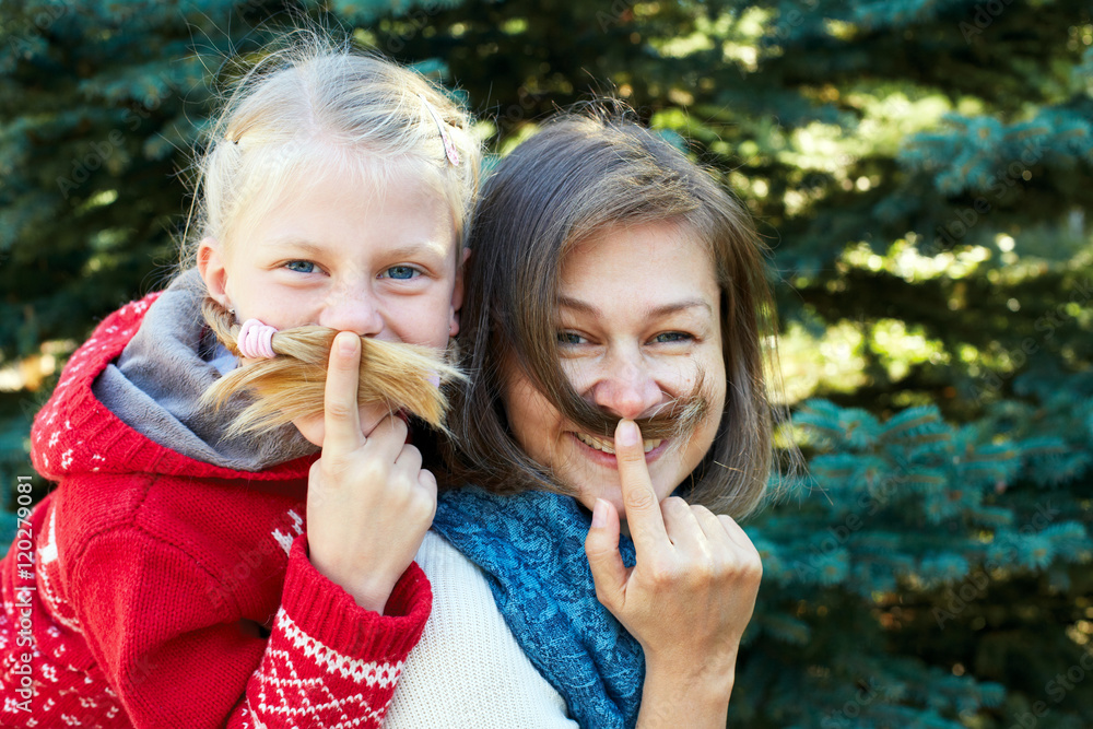 Funny family! Beauty funny girl holding hair - mustache. Beautif Funny family! Beauty funny girl holding hair - mustache. Beautif