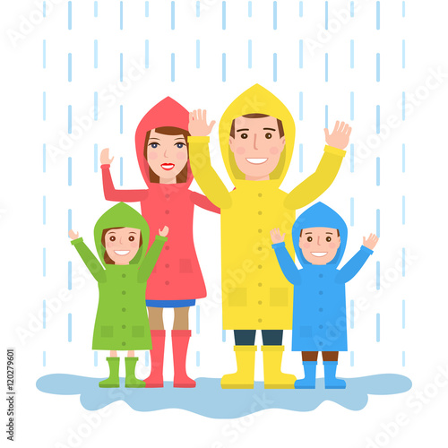 happy family in raincoats standing under the rain