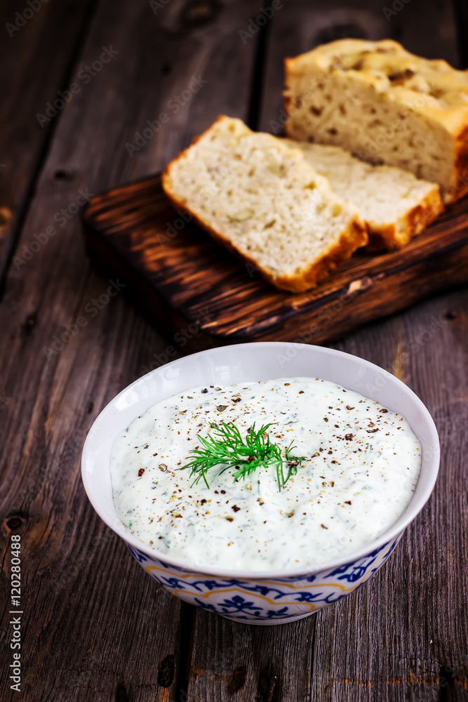 Multigrain bread,dill and spiced yoghurt on rustic background. Multigrain bread,dill and spiced yoghurt on rustic background.