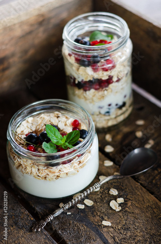 yogurt with berries and products for healthy breakfast, close-up
