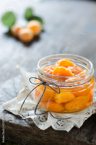 Apricot jam on wooden ground