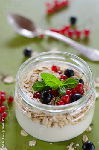 yogurt with berries and products for healthy breakfast, close-up
