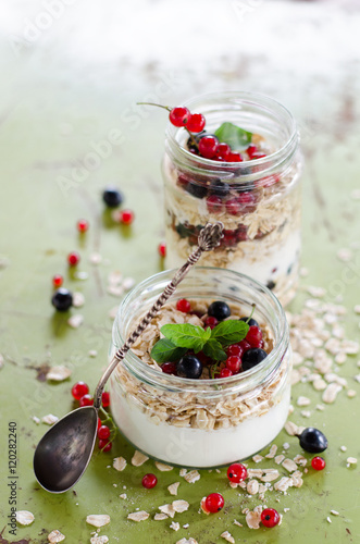 yogurt with berries and products for healthy breakfast, close-up
