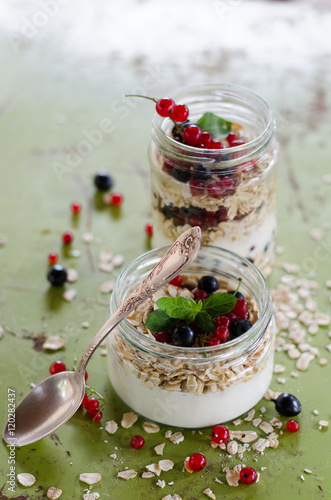 yogurt with berries and products for healthy breakfast, close-up
