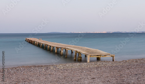 Wooden jetty at Ipsos beach, Corfu island, Greece photo