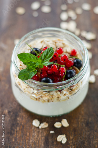 yogurt with berries and products for healthy breakfast, close-up
