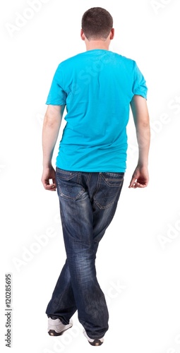 Back view of young men in blue t-shirt and jeans. Guy looks away. Rear view people collection. backside view of person. Isolated over white background.
