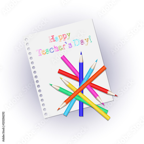 Scattered colored pencils on a white sheet notepad. Inscription happy Teachers' Day.