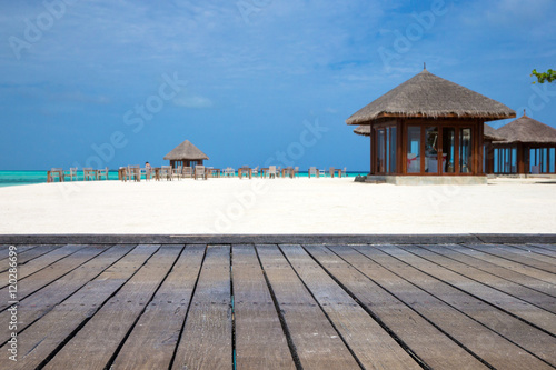 tropical beach in Maldives with few palm trees and blue lagoon