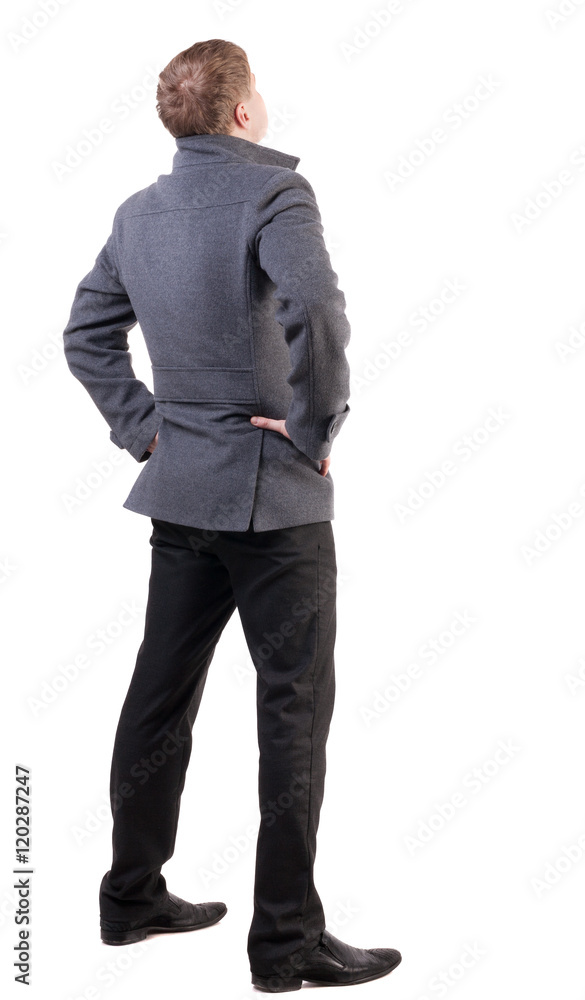 back view of Business man looks ahead. Young guy in coat watching. Rear view people collection. backside view of person. Isolated over white background. back view of Business man looks ahead. Young guy in coat watching. Rear view people collection. backside view of person. Isolated over white background.