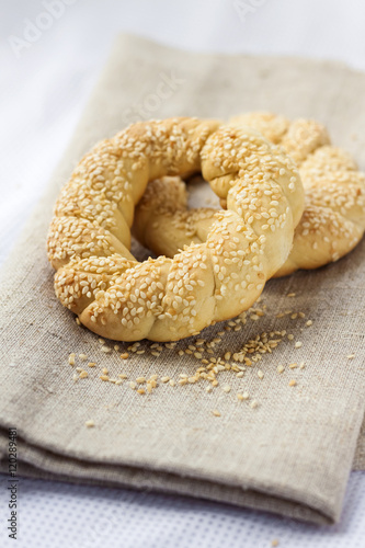 Two homemade bagels with sesame on a gray canvas
