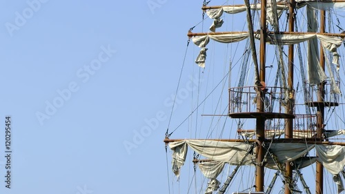 Detailed pirate mast and sails rocking in the wind on a bright day