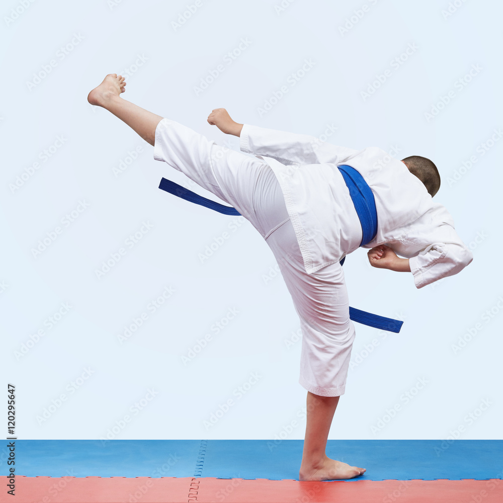 Kick leg athlete is beats in karategi Kick leg athlete is beats in karategi