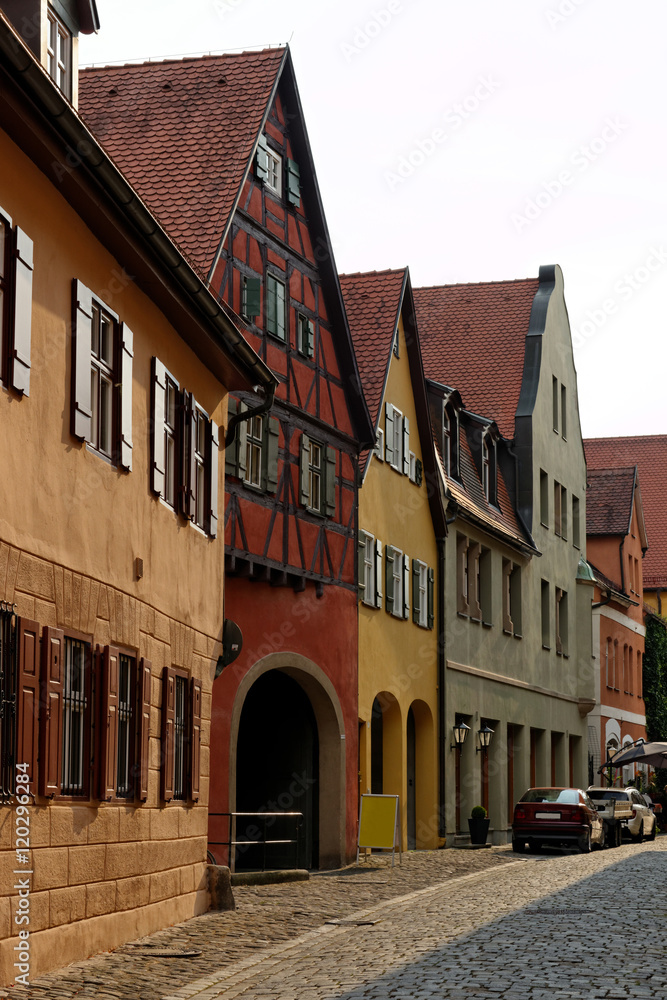 Obraz premium Traditional architecture in the old town of Dinkelsbuhl at sunset. It is one of the best-preserved medieval towns in Europe, part of the famous Romantic Road.