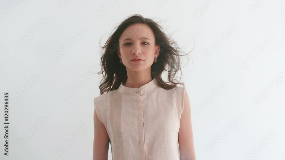 Young woman looking into camera and falling down in fog Young woman looking into camera and falling down in fog