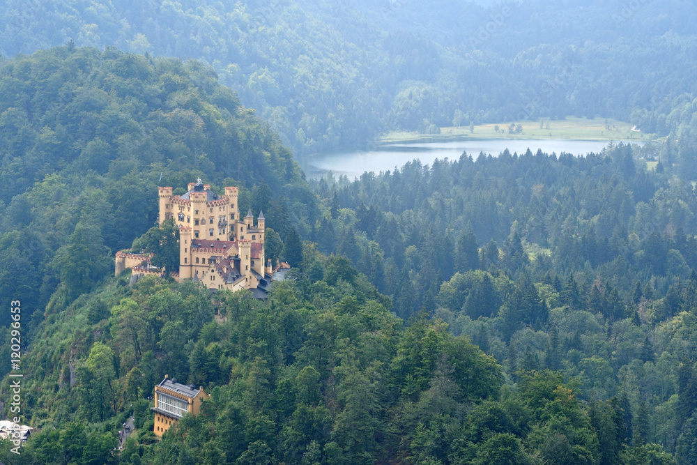 View of Hohenschwangau Castle in a summer misty day near the lake Alpsee in Bavaria, Germany.