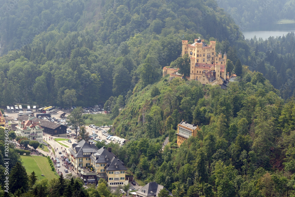 View of Hohenschwangau Castle in a summer misty day near the lake Alpsee in Bavaria, Germany. View of Hohenschwangau Castle in a summer misty day near the lake Alpsee in Bavaria, Germany.