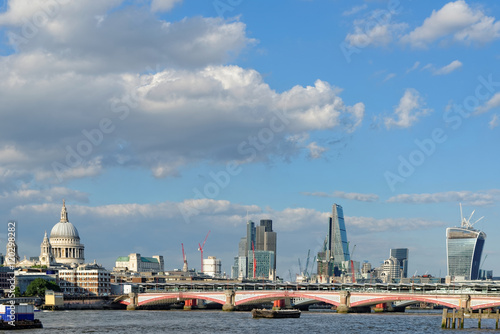 A view of Blackfriars bridge - a road and foot traffic bridge, over the river Thames against a background of St Paul Cathedral, the City and the Blackfriars railway bridge. photo