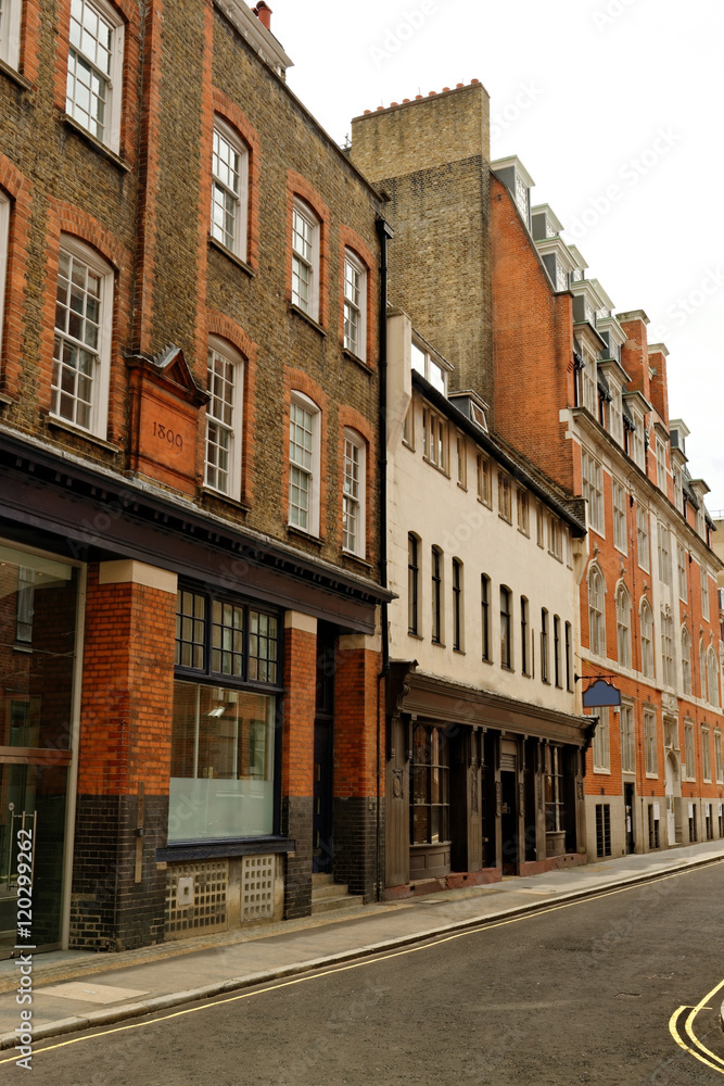 Street with traditional red brick houses in central London, England.