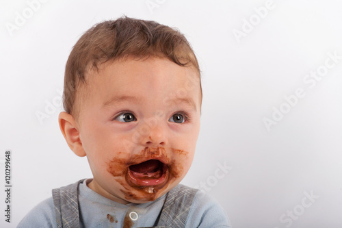 Baby boy happy after eating chocolate