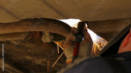 Mechanic Welding Muffler Of Car Exhaust System