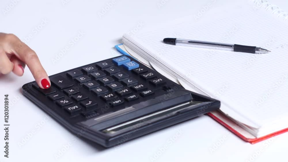 Girl makes the calculations and writes the numbers in a notebook. Close up Girl makes the calculations and writes the numbers in a notebook. Close up