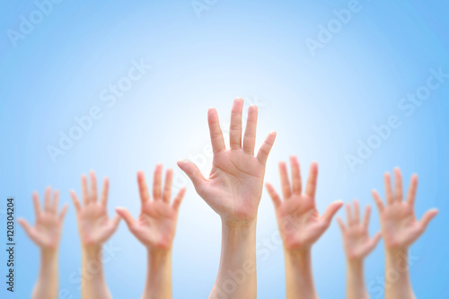 Many people blur hands raising up upward on white background showing vote, volunteering, participation concept/ campaign