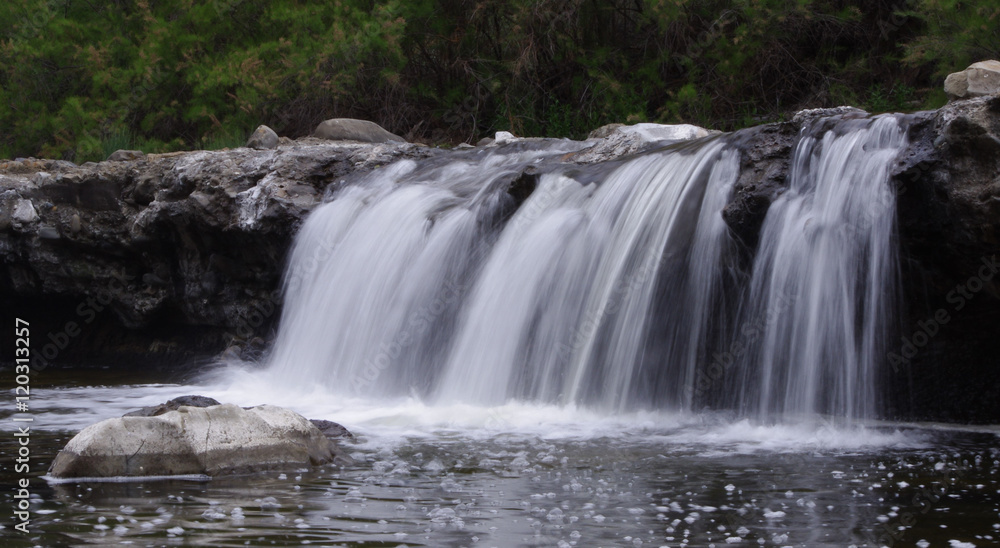 Fototapeta premium Smooth waterfall rocks
