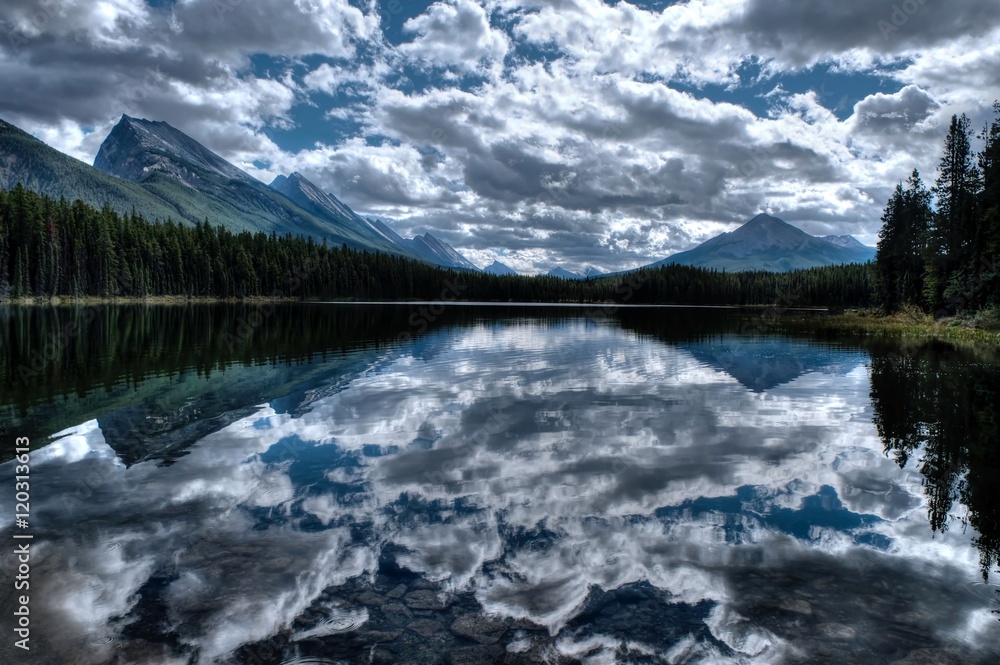 Clear water, mountains and reflections. Honeymoon lake. Banff National Park. Alberta. Canada. 