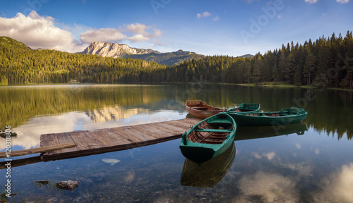 Alpine lake at dawn, beautifully lit mountains