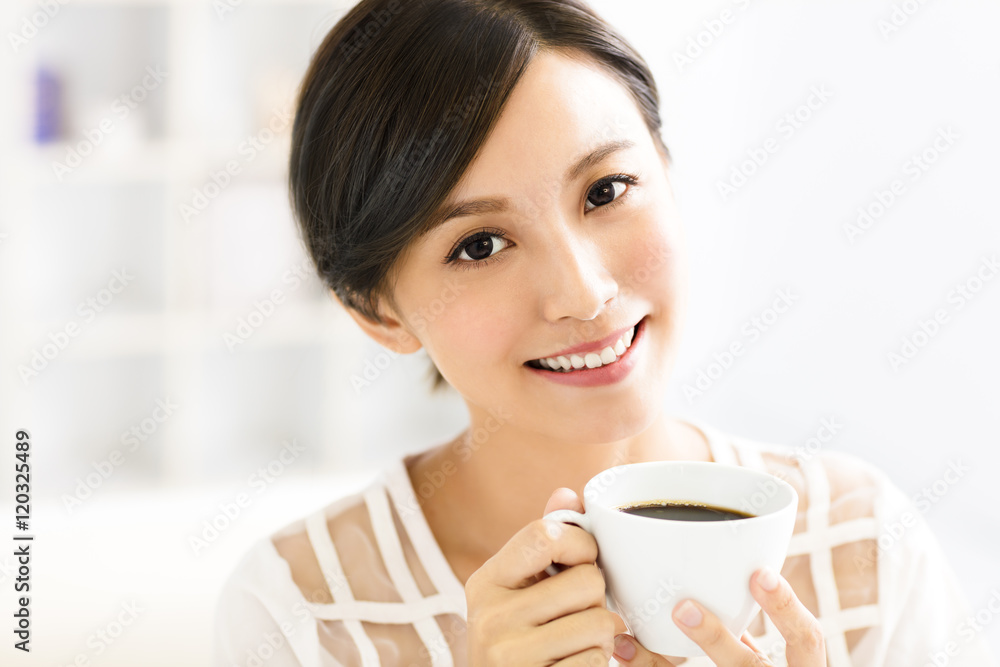young smiling woman drinking coffee in the morning young smiling woman drinking coffee in the morning