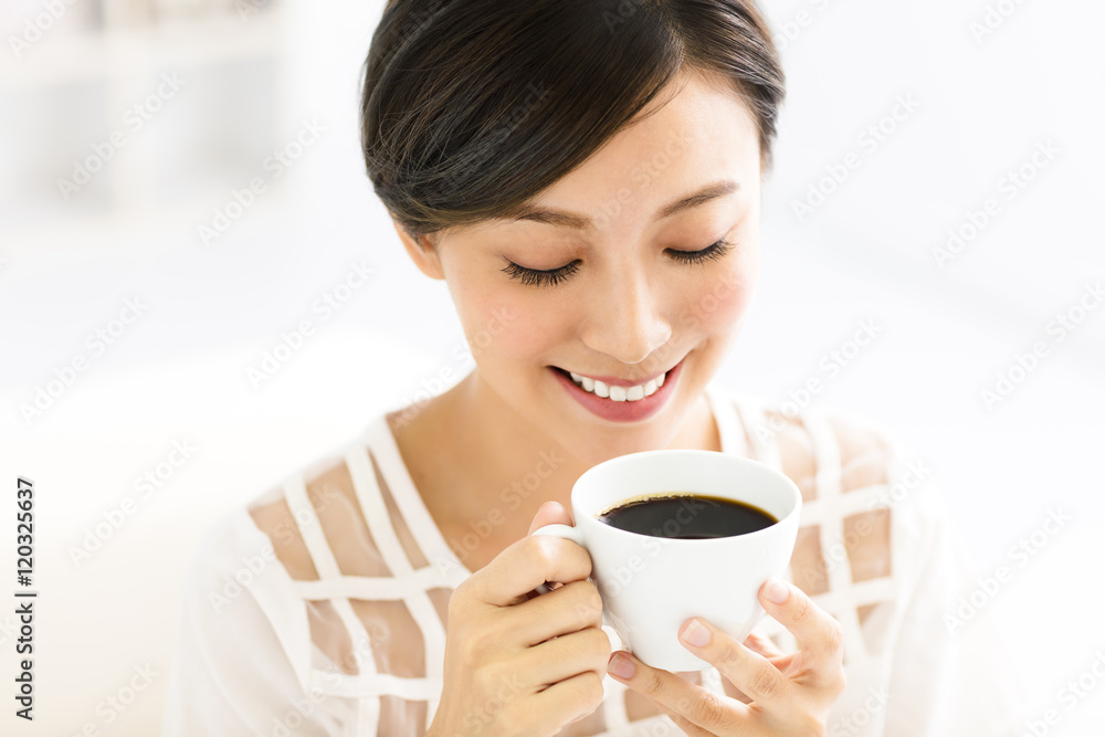 young smiling woman drinking coffee in the morning young smiling woman drinking coffee in the morning