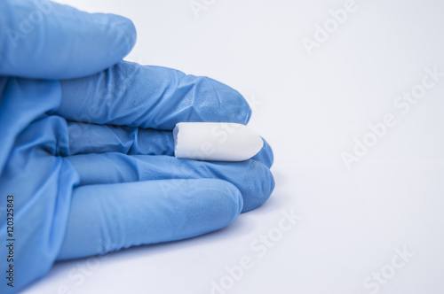 фотографія Suppository with medicine (laxative or to treat proctological diseases) lies in
