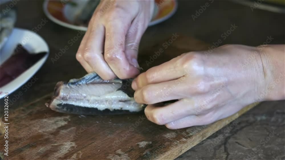 The chef removes the skin from fish to salads The chef removes the skin from fish to salads