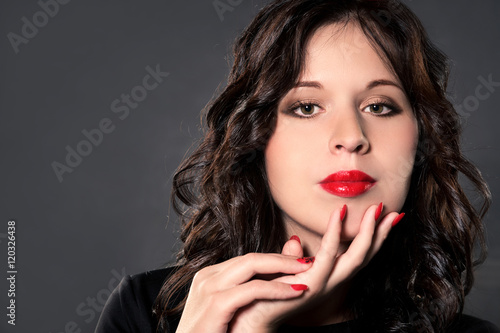 beautiful brunette with bright lipstick and nails 