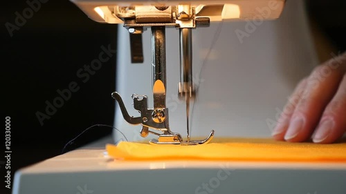 Woman sewing on the sewing machine - slow motion