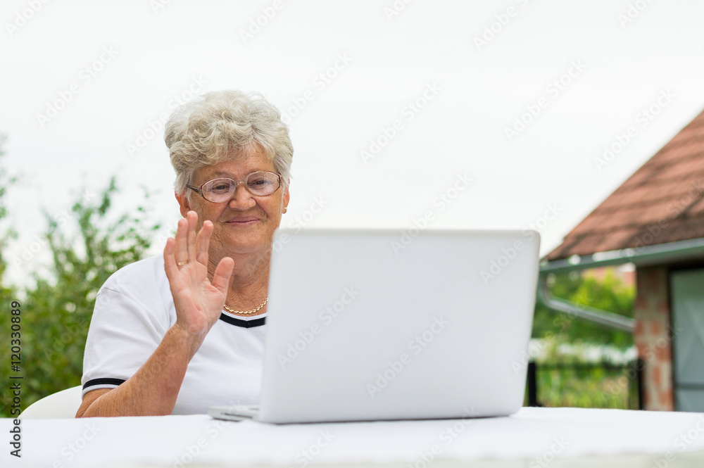 Modern grandma talking on the skype with family Modern grandma talking on the skype with family