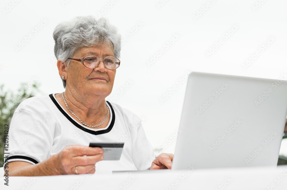 Grandmother buying online with credit card Grandmother buying online with credit card