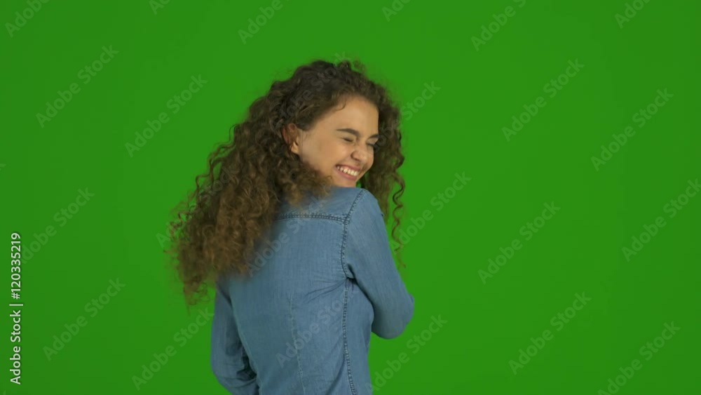 2 in 1 video! The young curly woman flirt and stand on the green background. Real time capture 2 in 1 video! The young curly woman flirt and stand on the green background. Real time capture