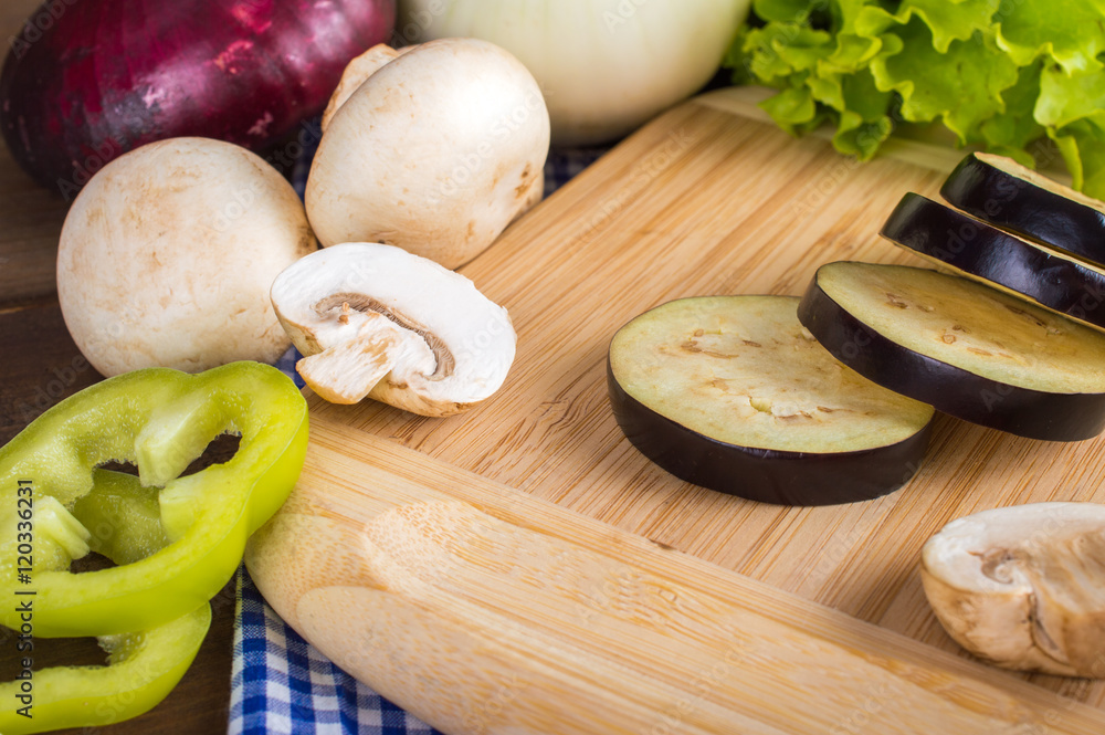 Healthy eating, diet concept - sliced vegetables on a cutting board on a wooden table. Healthy eating, diet concept - sliced vegetables on a cutting board on a wooden table.