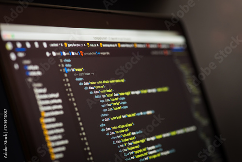 HTML and CSS code developing screenshot. Laptop screen. photo