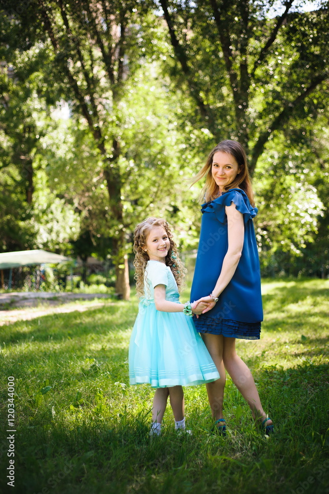 Happy daughter smiling at camera in park Happy daughter smiling at camera in park