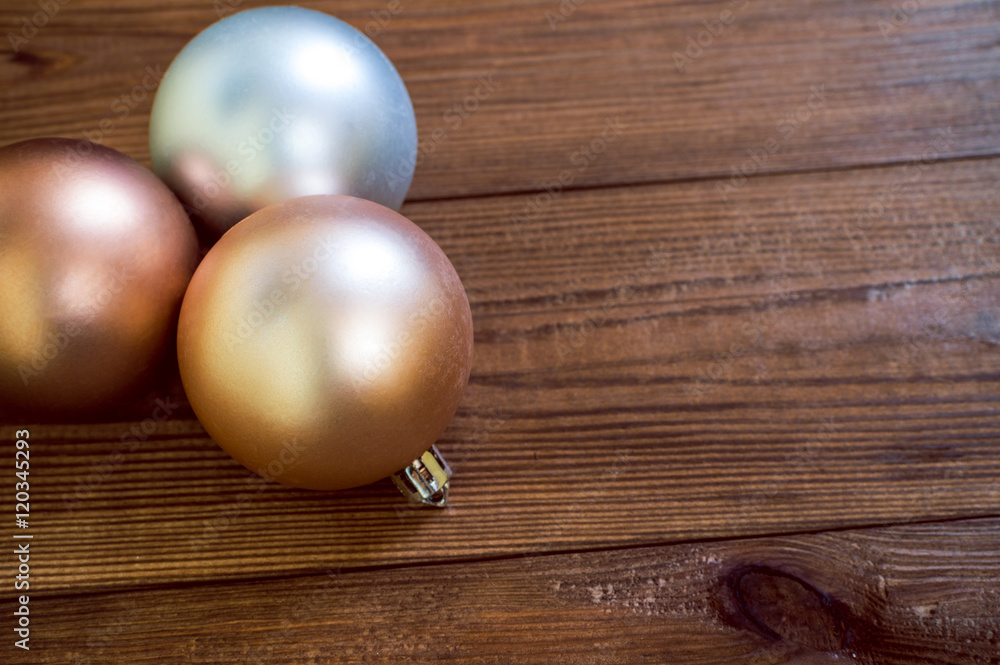 Golden christmas balls on the wooden table